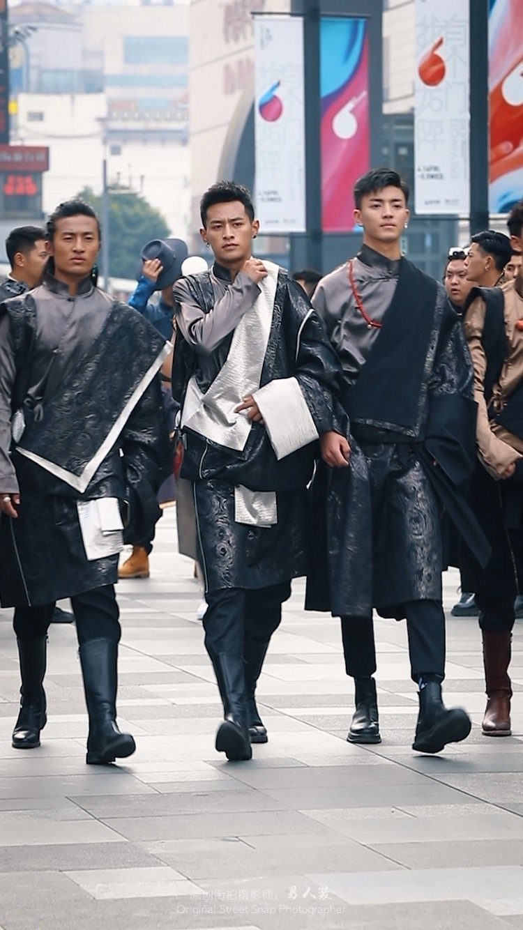 Three men walking in an urban setting wearing avant-garde black and white layered streetwear.