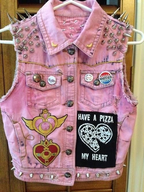 A pink studded denim vest featuring Sailor Moon patches and a pizza heart graphic.