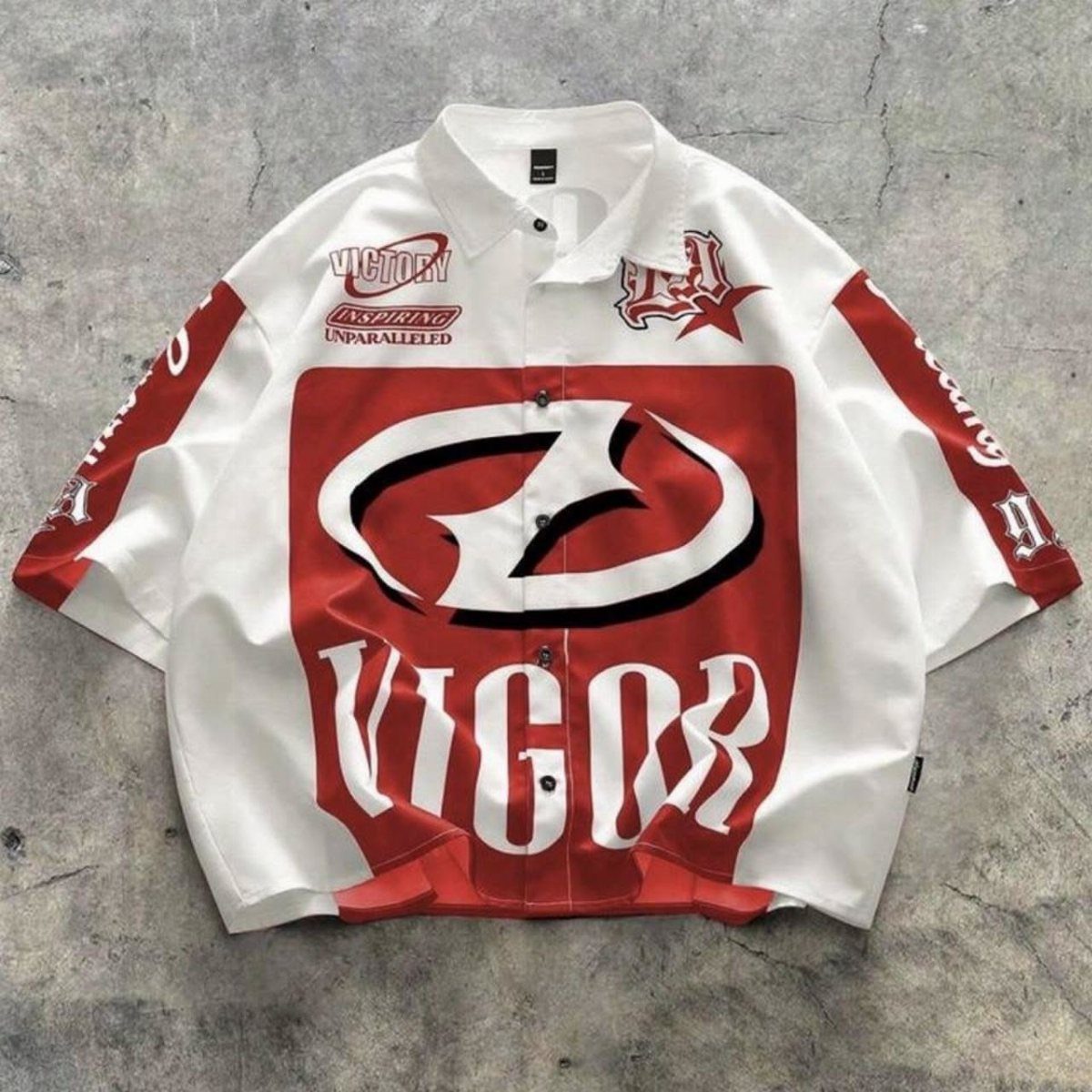 A white and red graphic button-down shirt with large stylized logos and text.